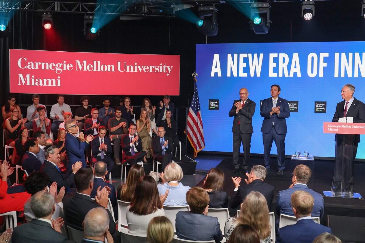 Billionaire businessman and real estate developer Moishe Mana, left, is acknowledged by Ken Griffin, founder and CEO of Citadel, right, during the announcement of Carnegie Mellon University Miami at the Wynwood site Mana sold, Thursday, Oct. 1, 2026, in Miami.