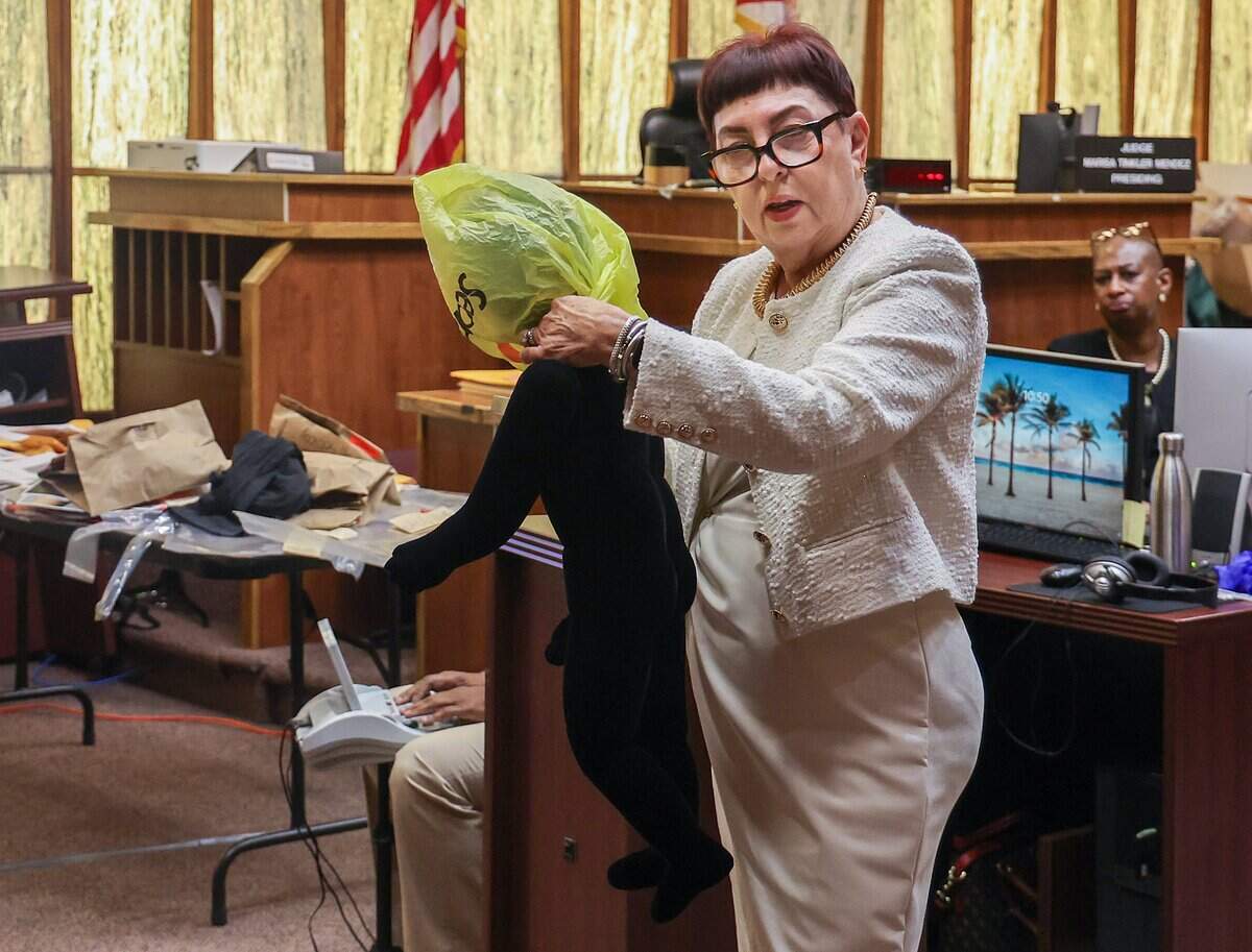 Prosecutor Abbe Rifkin demonstrates the suffocation of one of the young victims as she addresses the jury during closing arguments in the death penalty sentencing trial of Alberto Sierra on Monday, Oct. 19, 2026. Sierra is facing the death penalty for murdering his wife and her two young daughters.