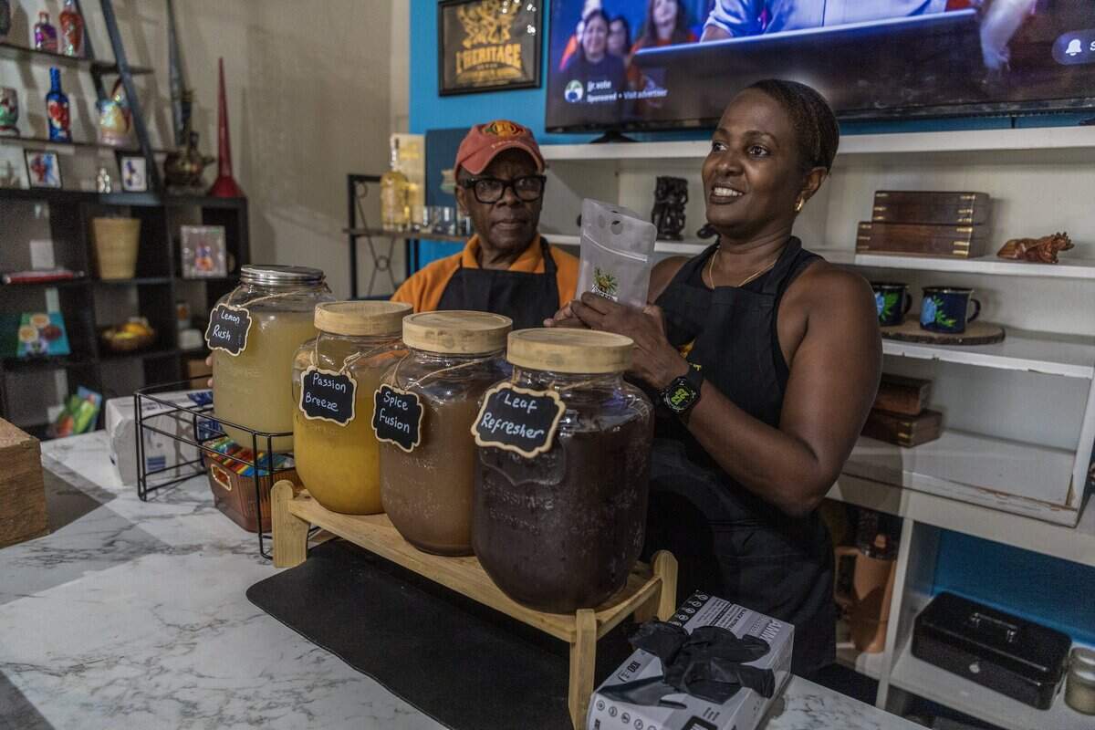 Weber Pierre Louis (left) helps Francoise Penha, owner of the Spiced Hut Beverages during a pop up sampler of the company juices at Tanbou Collective, a local Haitian and Caribbean gift shop and cultural boutique located in the Little Haiti, in Miami, Florida, on Saturday October 17, 2026.