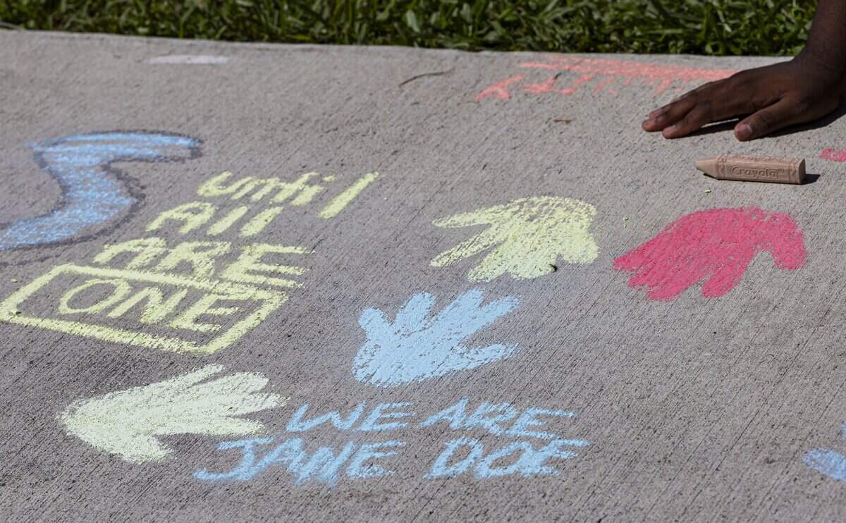 Activists use chalk to write messages during a protest in front of the Alvin Sherman Library at Nova Southeastern University on Thursday, Oct. 15, 2026, in Davie, Fla. Students are protesting the university's handling of allegations involving a former Cornell University student who is accused in a sexual assault lawsuit.
