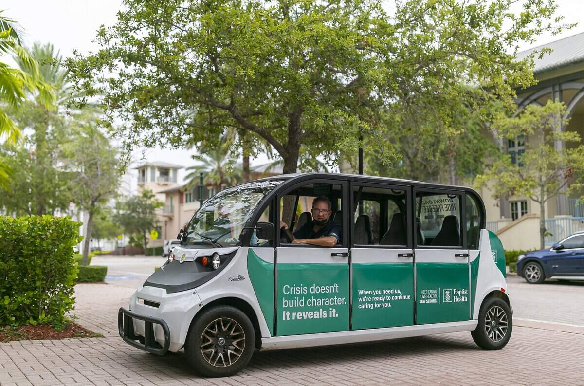 Luis Somoza drives a Freebee near West McIntyre Street in Key Biscayne, Florida, on Tuesday, Aug. 3, 2021.