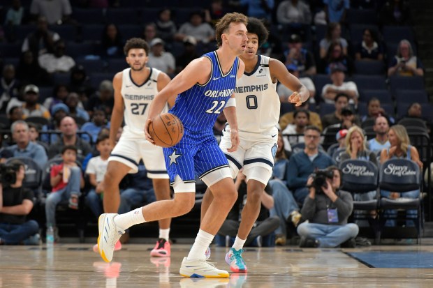 Orlando Magic forward Franz Wagner (22) handles the ball against Memphis Grizzlies forward Jaylen Wells (0) in the first half of an NBA basketball preseason game Wednesday, Oct. 7, 2026, in Memphis, Tenn. (AP Photo/Brandon Dill)