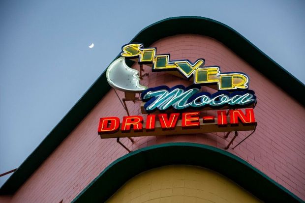 The moon rises over the neon sign of the Silver Moon Drive-In near Lakeland. (Patrick Connolly/Orlando Sentinel)