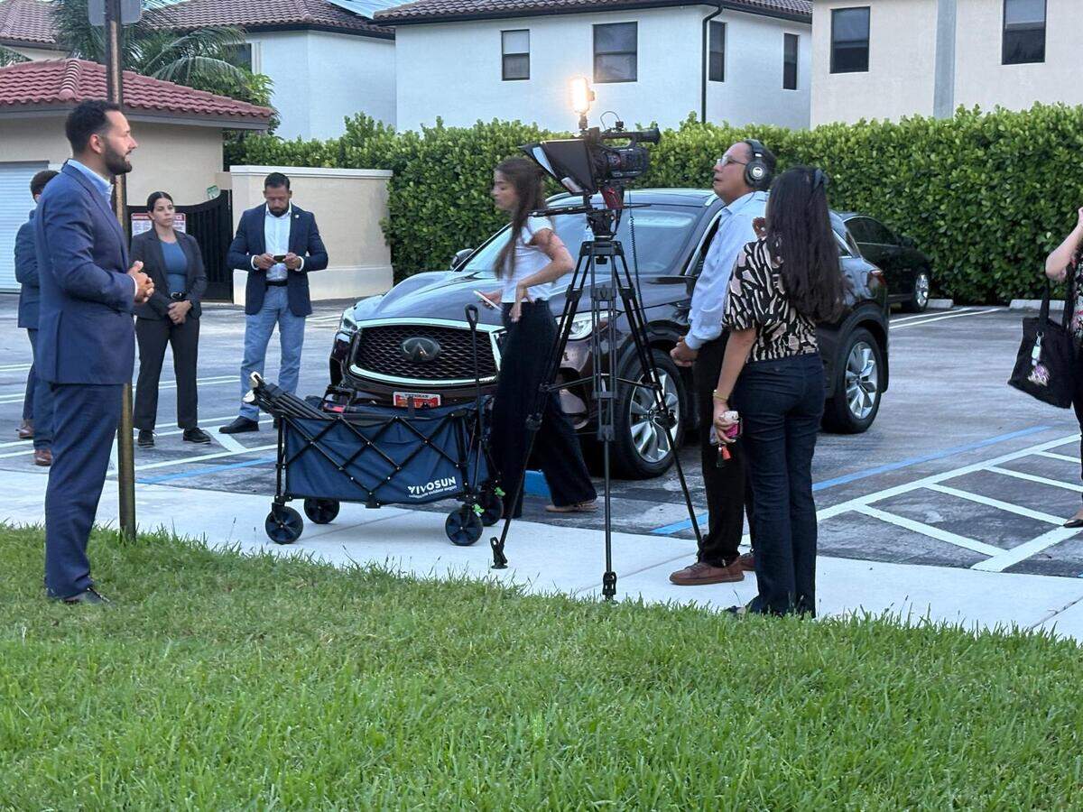 Hialeah Mayor Bryan Calvo during a town hall meeting at Hialeah Heights. In the background are members of his security detail, Rudy Ginestra and Aileen Perez. In the foreground are members of his digital and communications team.