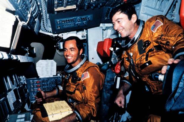 Astronauts Robert Crippen (left) and John Young (right) are seen in the flight deck of the space shuttle Columbia before the first shuttle flight at Kennedy Space Center in Florida on April 12, 1981.