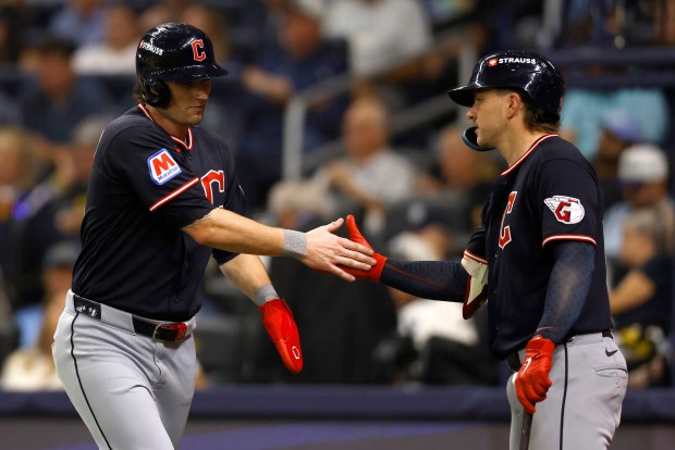 Chase DeLauter of the Cleveland Guardians celebrates a run with teammate Travis Bazzana during the sixth inning against the Tampa Bay Rays in Monday's Game 6 of the American League Championship Series in St. Petersburg, Fla.  (Photo by Mike Stobe/Getty Images)