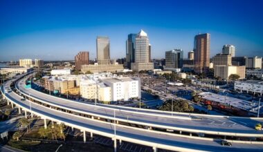Aerial view of the Lee Roy Selmon Expressway curving past downtown Tampa high-rise buildings, where a $362 million expansion is underway.