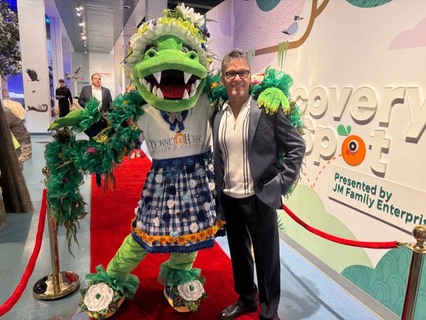Bonnet House mascot ambassador Bonnie Gator and Neil Goldberg, one of the filmmakers, at the premiere at the AutoNation IMAX 3D Theater in Fort Lauderdale's Museum of Discovery and Science. (Bonnet House Museum & Gardens/Courtesy)