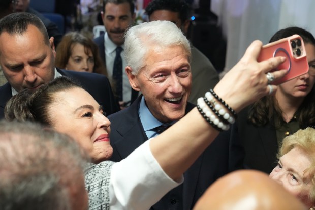 Former U.S. President Bill Clinton takes a photo with a supporter of Florida Democratic candidate for governor David Jolly, Tuesday, Oct. 20, 2026, in Hollywood, Fla. (AP Photo/Marta Lavandier)