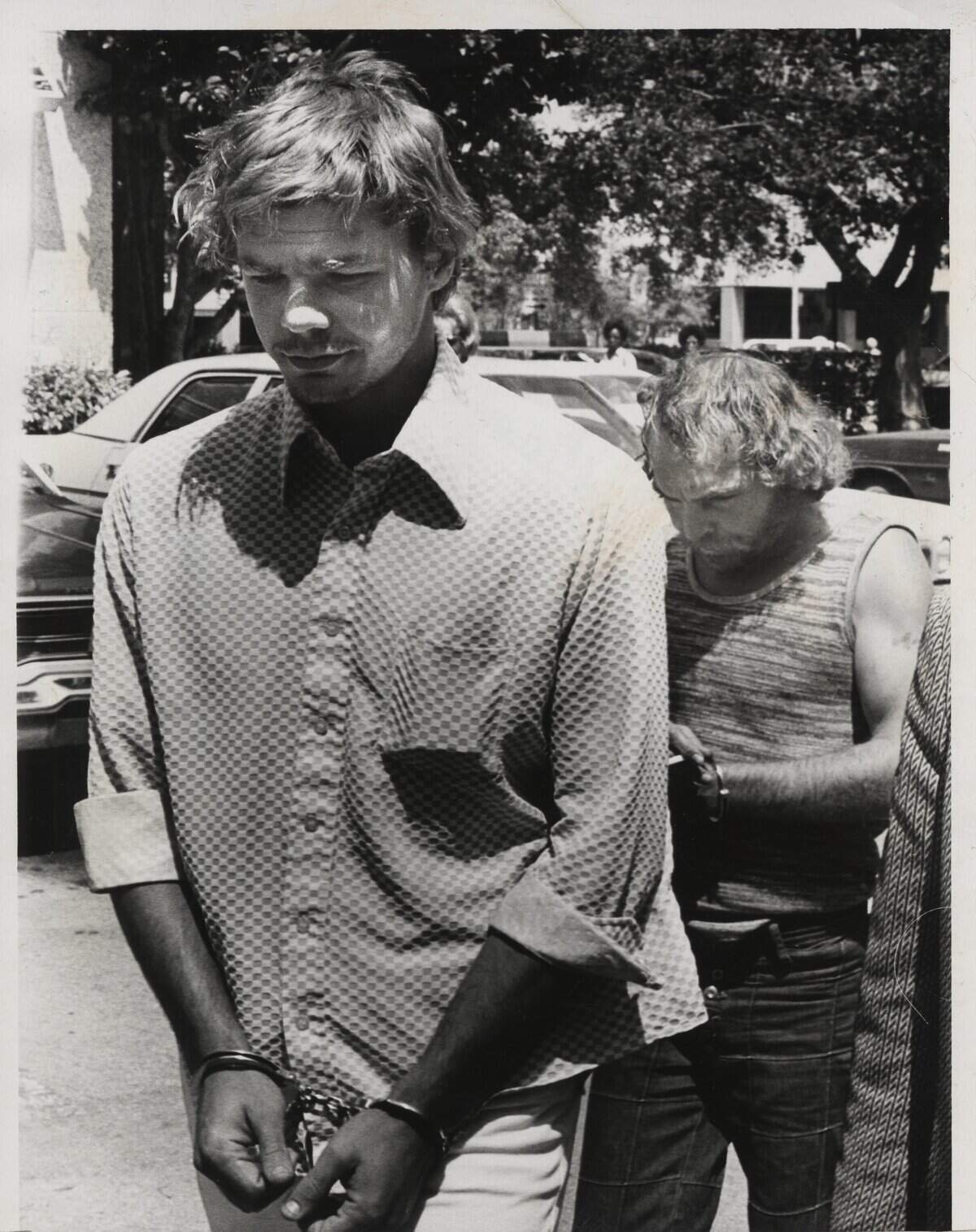 William Lee Thompson, left, and Rocco Surace after their arrest in 1976.