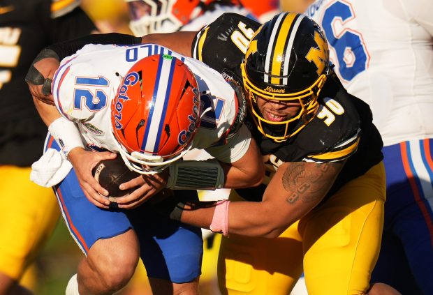 Florida quarterback Aaron Philo (12) is sacked by Missouri defensive tackle Sterling Webb (90) during the Gators' 45-17 loss Oct. 3 in Columbia, Missouri. (AP Photo/Jeff Roberson)