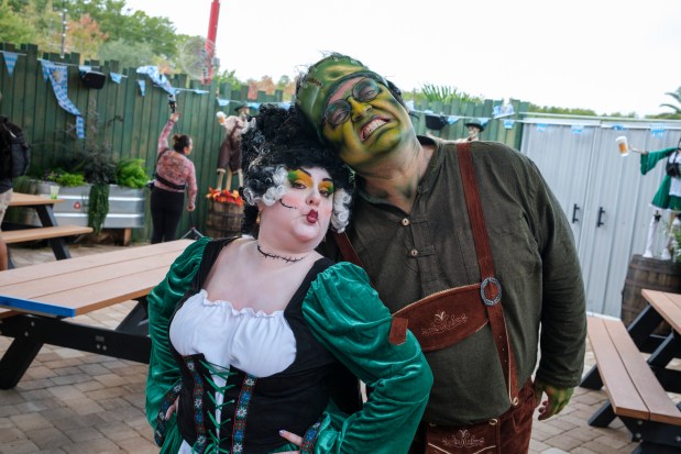 Frankenstein and his bride are roaming characters found at Frank N' Steins Oktoberfest during Gators, Ghosts and Goblins at Gatorland on Oct. 8, 2026. (Patrick Connolly/Orlando Sentinel)