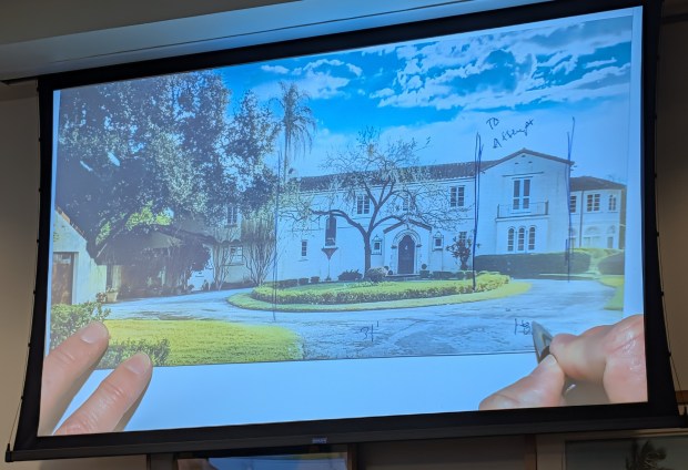 Orlando real estate attorney Jason Searl writes on a printed image of the Merrywood mansion in Winter Park displayed on screens during the Winter Park City Commission meeting on Wednesday, Oct. 14, 2026. Searl was doing it during discussions on saving the center part of the home and attempt to save the other part on behalf of the new owner, Steve Lockwood. (Brian Bell/Orlando Sentinel)