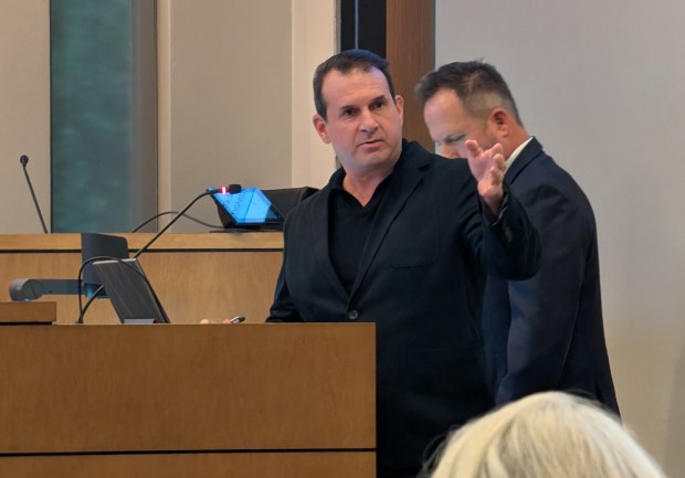 Steve Lockwood, left, the new owner of the land where the iconic Merrywood mansion sits, speaks toward Betsy Rogers Owens, executive director of Friends of Casa Feliz and granddaughter of James Gamble Rogers II, during the Winter Park City Commission meeting on Wednesday, Oct. 14, 2026. Next to him is Jason Searl, an Orlando real estate attorney. (Brian Bell/Orlando Sentinel)