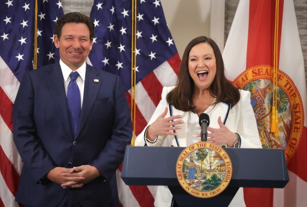 Florida Attorney General Ashley Moody responds to cheering supporters after Governor Ron DeSantis, left, announced her appointment as U.S. senator to replace Marco Rubio, during a press conference at the Rosen Plaza Hotel in Orlando, Fla., Thursday, Jan. 16, 2025. Rubio has been nominated by president-elect Donald Trump to be the next U.S. Secretary of State. (Joe Burbank/Orlando Sentinel)