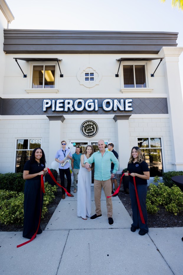 Pierogi One co-owners and longtime friends and business partners Iwona Wawer (left) and Pawel Redestowicz cut the ribbon on their new Orlando eatery back in June. (Photo courtesy Pierogi One)