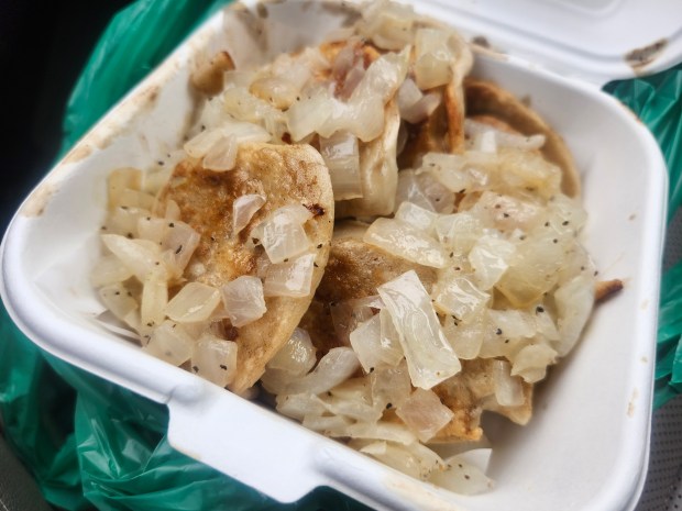 A takeout container of onion-slathered pierogi from Pierogi Bros in Sanford. (Amy Drew Thompson/Orlando Sentinel)