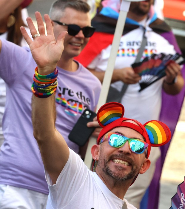 Disney cast members march in the Come Out With Pride parade as it makes its way down Orange Avenue in downtown Orlando, Saturday, Oct. 18, 2025.Come Out With Pride is the annual day-long festival at various venues in downtown celebrating the LGBTQIA+ community in Central Florida. More than 200,000 visitors attended the festivities, according to the City of Orlando, including the parade, fireworks, live music, and more. (Joe Burbank/Orlando Sentinel)