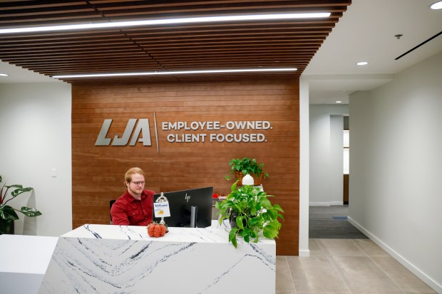 LJA Engineering colleagues discuss a project at the engineering consulting firm's Maitland office on Monday, September 21, 2026. (Rich Pope/Orlando Sentinel)