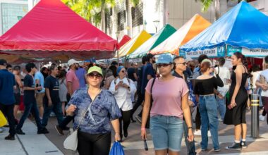 Crowd browsing books at the Miami Book Fair street fair