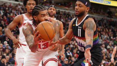 Feb 7, 2026; Chicago, Illinois, USA; Chicago Bulls center Nick Richards (13) grabs a rebound in front of Denver Nuggets guard Bruce Brown (11) during the first half at United Center.