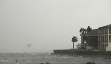 A house is battered by the strong winds and storm surge of Hurricane Isaias in Pensacola, Florida, on Oct. 9, 2026. Hurricane Isaias' outer bands were lashing the US Gulf Coast with heavy rain and strong winds Friday, with the category 3 storm triggering mandatory evacuations and poised to bring life-threatening storm surge when it makes landfall.