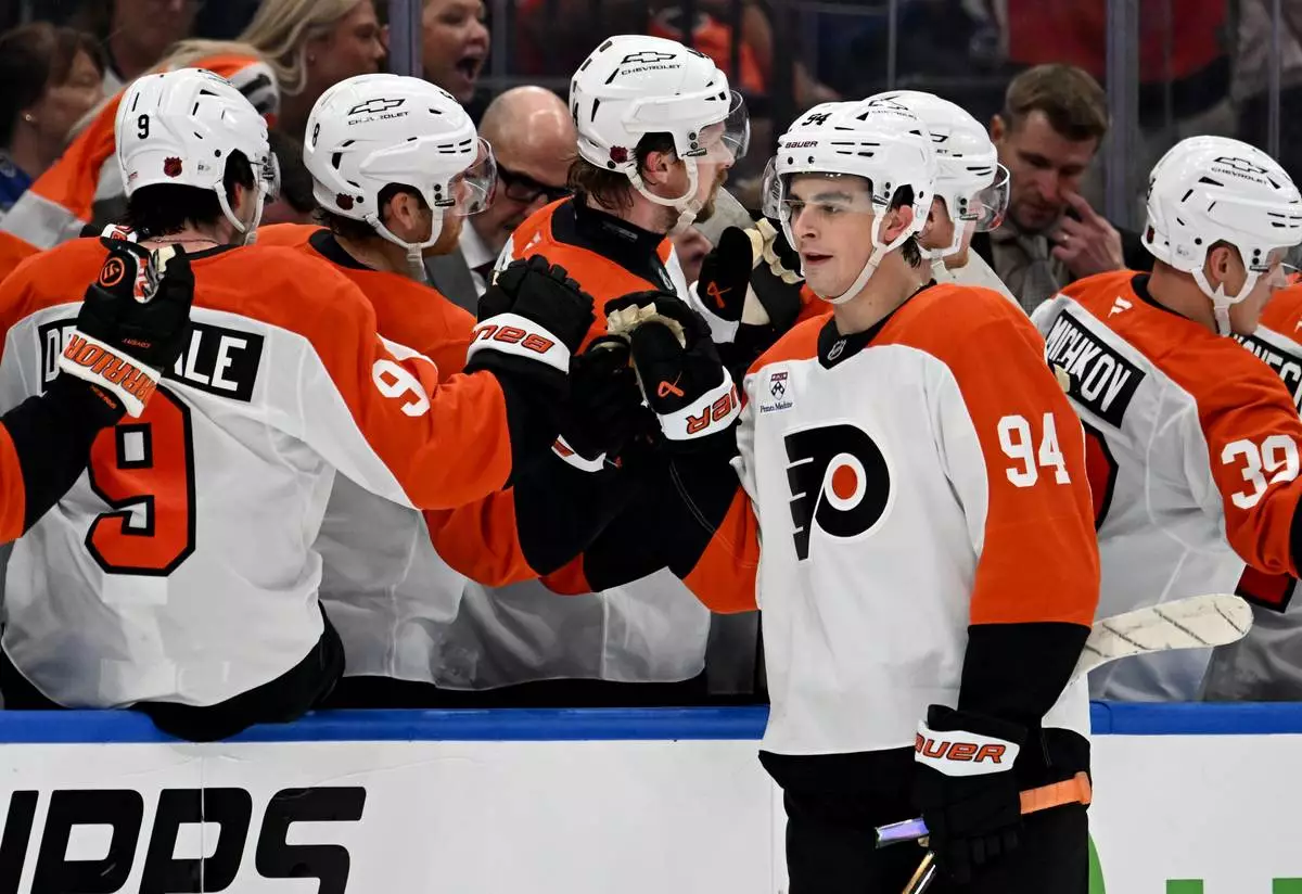 Philadelphia Flyers right wing Porter Martone (94) celebrates after his goal during the second period of an NHL hockey game against the Tampa Bay Lightning, Monday, Oct. 5, 2026, in Tampa, Fla. (AP Photo/Jason Behnken)