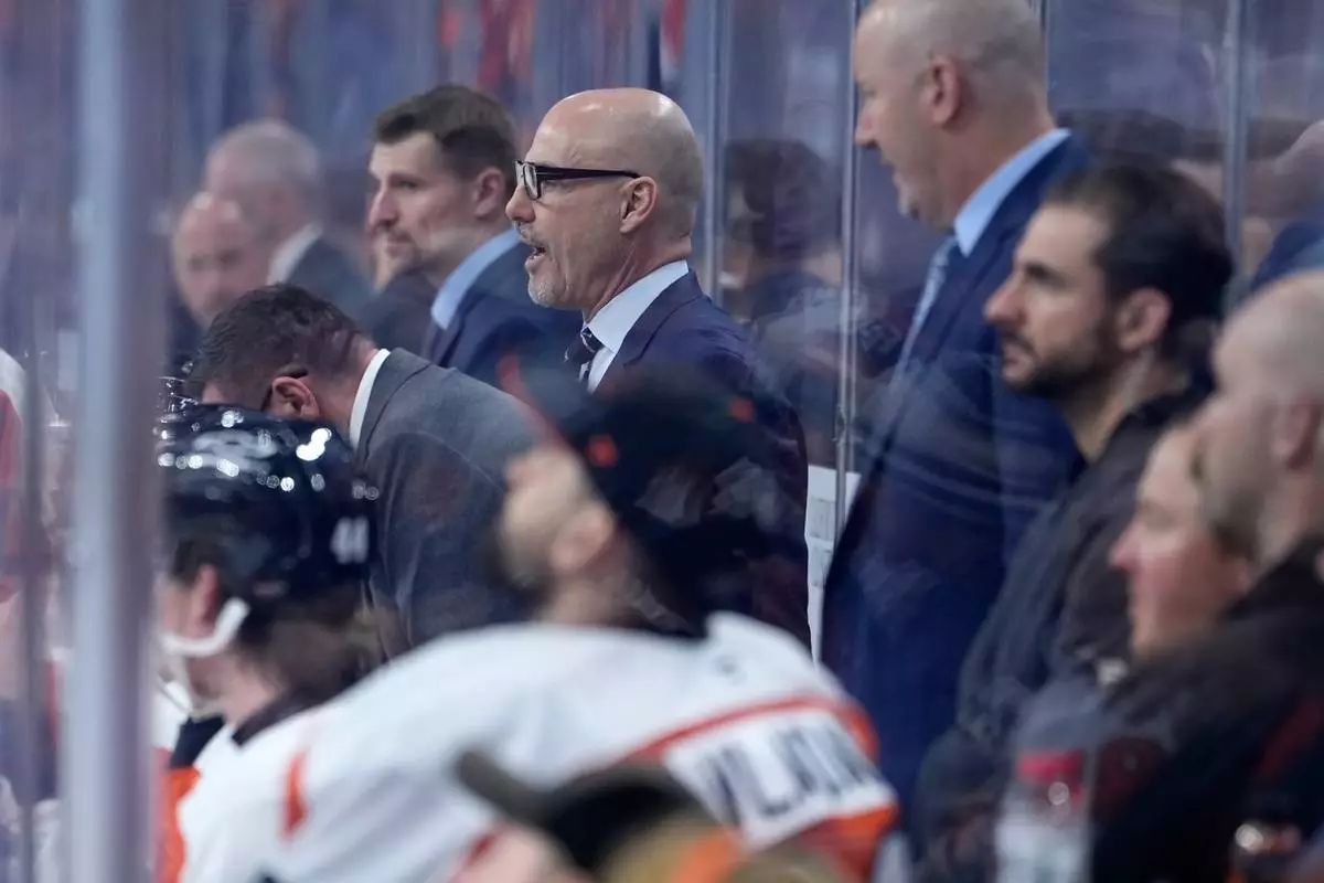 Philadelphia Flyers' Rick Tocchet coaches during the third period of an NHL hockey game against the Carolina Hurricanes Sunday, Oct. 11, 2026, in Philadelphia. (AP Photo/Matt Slocum)