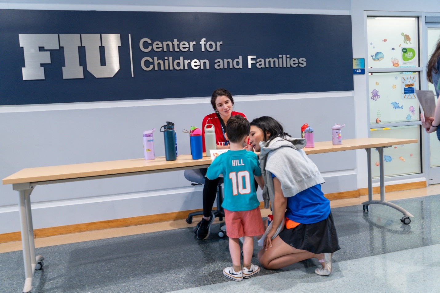 Brave Bunch counselors Debi Gonzalez and Shasha Zhu encouraging a child to participate in the activity