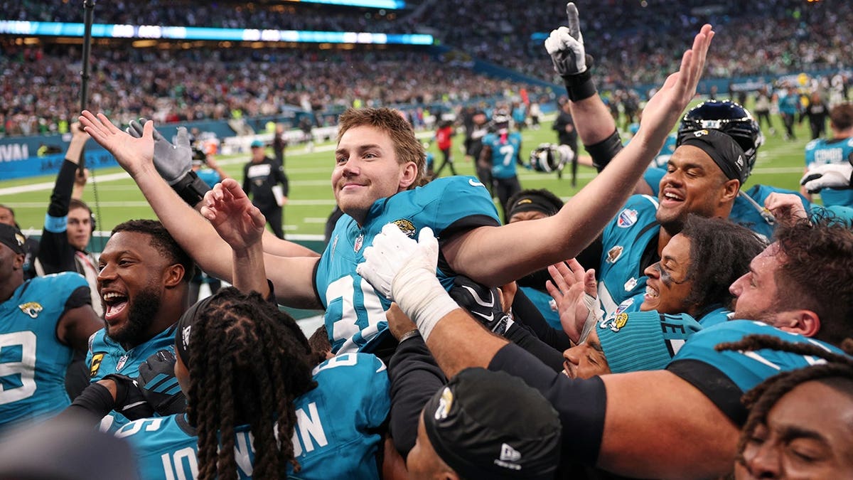 Cam Little celebrates after scoring the winning field goal during an NFL game.
