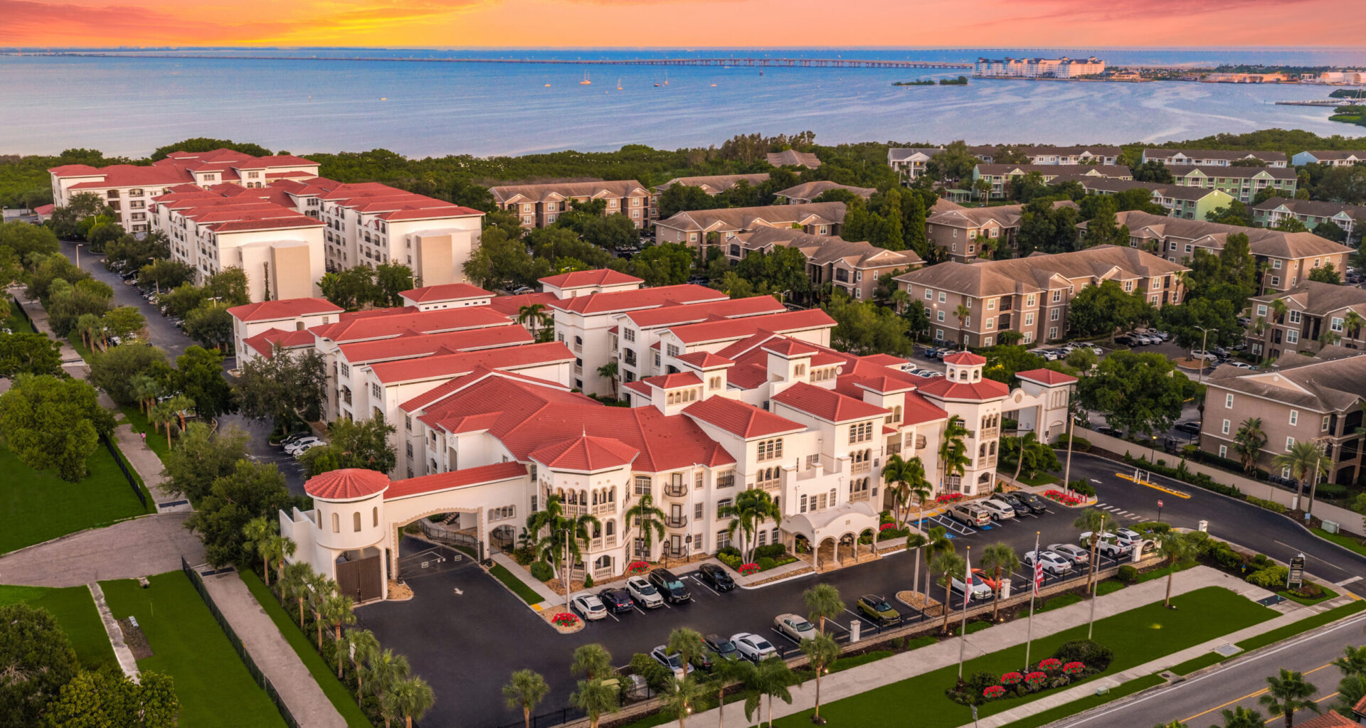 Aerial view of Casa Bella on Westshore apartment complex in South Tampa, featuring red-roofed buildings along Tampa Bay.
