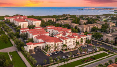 Aerial view of Casa Bella on Westshore apartment complex in South Tampa, featuring red-roofed buildings along Tampa Bay.