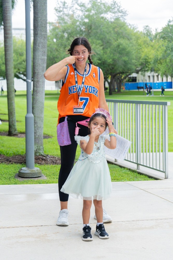 Brave Bunch counselor Maggie Modico encouraging Hailey to participate in the activity.
