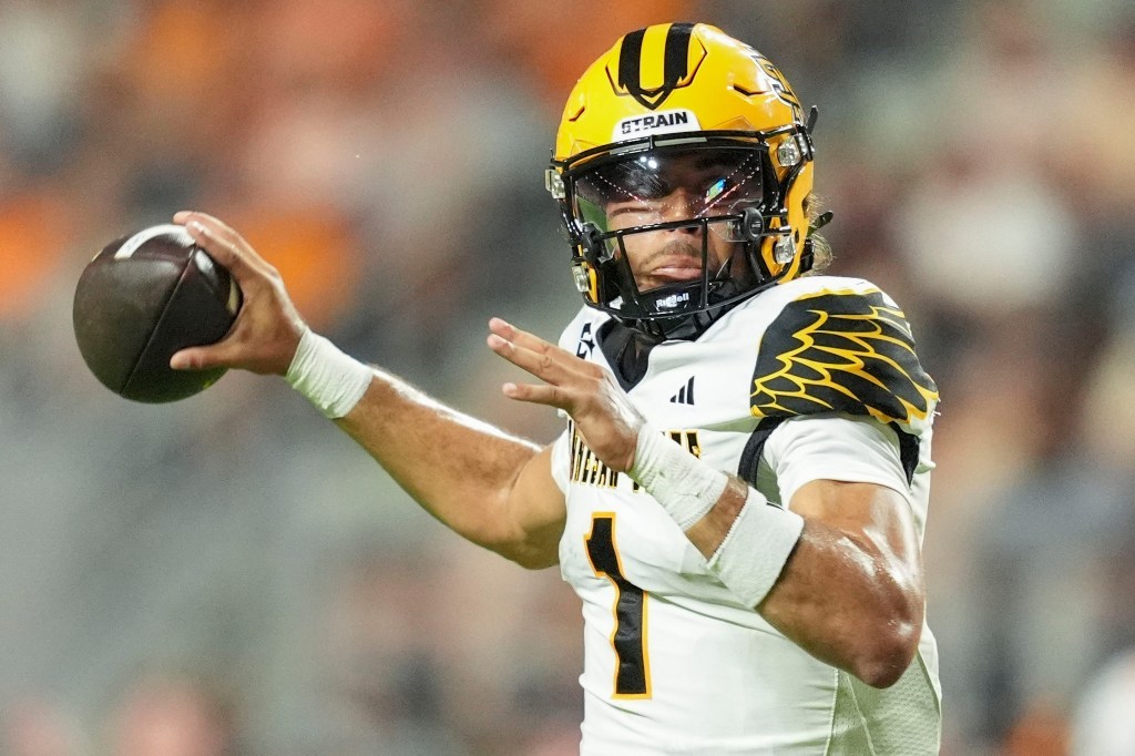 Kennesaw State quarterback Rickie Collins (1) drops back to pass during a college football game against Tennessee.
