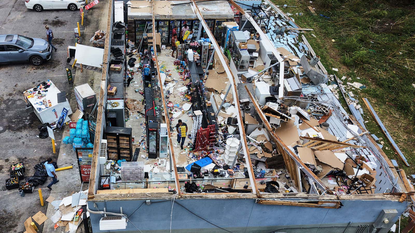 People salvage the contents of their destroyed mini mart in the aftermath of Hurricane Isaias in Milton, Fla., Saturday, Oct. 10, 2026.
