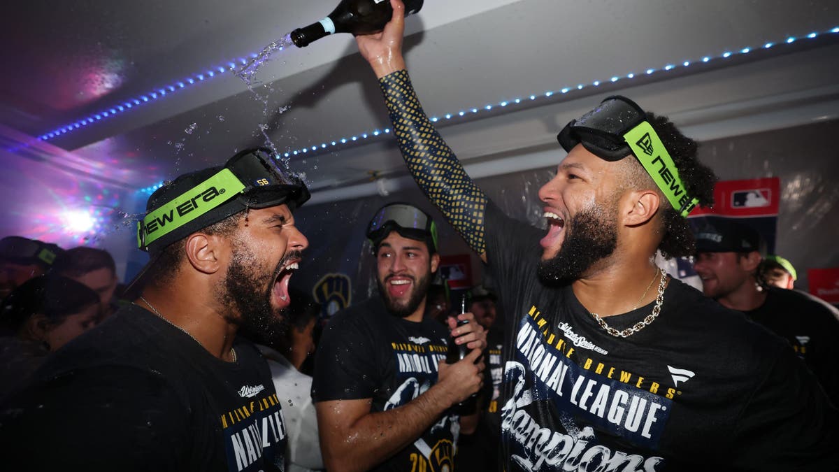 Jackson Chourio celebrates in the Milwaukee Brewers clubhouse after a playoff win.