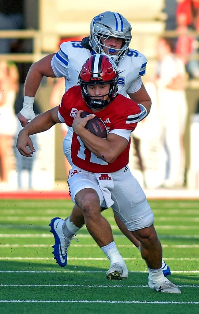 Jax State quarterback Caden Creel tries to evade the tackle of Middle Tennessee defensive end Aidan Butts during a college football game.