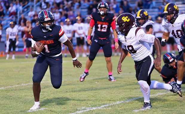 Gateway running back Nydrell Thigpen tries to get to the outside around St. Cloud defender Marcus Saintil during St. Cloud's 28-21 victory Friday night, Oct. 2, 2026. (Chris Hays/Orlando Sentinel)