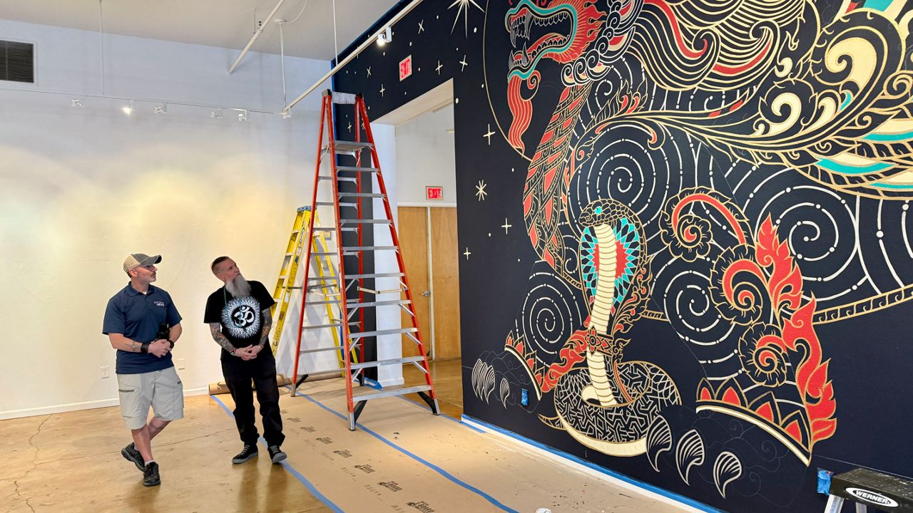 Chris Sparks, the artist known as Palehorse, pauses his indoor mural work at the Morean Arts Center in St. Pete to speak with Spectrum Bay News 9 photojournalist Matt Infante. The Palehorse solo show opens October 10th and shows through December 31st. (Spectrum News/Virginia Johnson)
