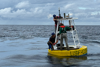 Researchers deploy a buoy in the Gulf during a recent cruise.