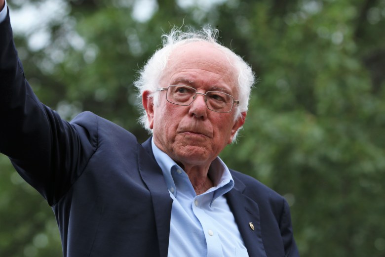 Vermont Senator Bernie Sanders gesturing while addressing a crowd at a 2020 Democratic presidential campaign rally in Des Moines, Iowa.