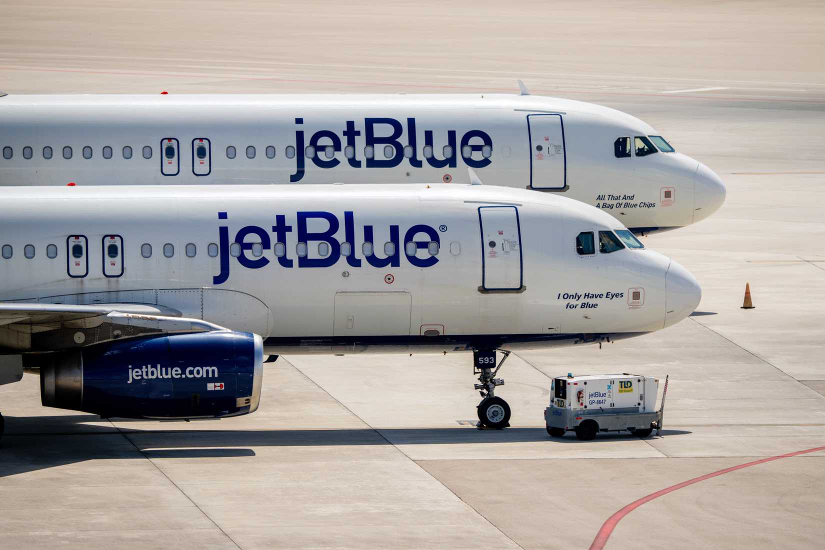 Two JetBlue Airbus A320s parked at West Palm Beach Airport