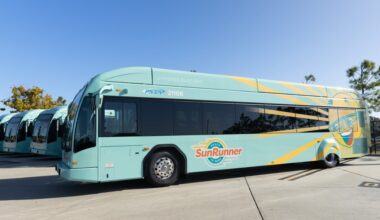 Turquoise PSTA SunRunner hybrid-electric bus parked alongside other buses in St. Petersburg