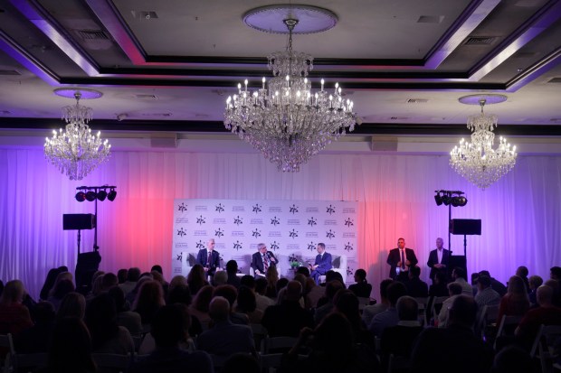 Congressional District 25 candidates, former Boca Raton Mayor Scott Singer, left, and U.S. Rep. Jared Moskowitz, right, participate in a candidate forum with South Florida Sun Sentinel political reporter Anthony Man, center, at Congregation B'nai Israel in Boca Raton on Tuesday, Oct. 20, 2026. (Mike Stocker/South Florida Sun Sentinel)