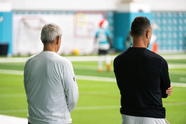 Miami Dolphins general manager Jon-Eric Sullivan and his father, longtime college football and NFL assistant coach Jerry Sullivan, during the NFL team's practice on Oct. 9 in Miami Gardens. (Tomas Diniz Santos/Courtesy of Miami Dolphins)