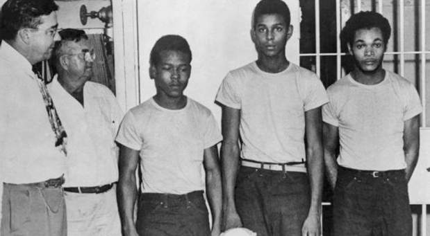 Lake County Sheriff Willis McCall, far left, and an unidentified man stand next to Walter Irvin, Samuel Shepherd and Charles Greenlee, from left, in Florida. The three men along with a fourth were charged with rape in 1949. Florida Gov. Ron DeSantis and a Cabinet granted posthumous pardons in 2019. (State Library and Archives of Florida)