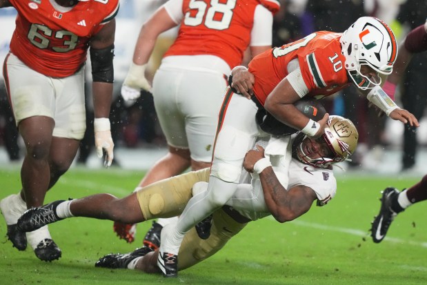 Florida State defensive lineman Rylan Kennedy sacks Miami quarterback Darian Mensah (10) during the first half of an NCAA college football game, Saturday, Oct. 17, 2026, in Miami Gardens, Fla. (AP Photo/Lynne Sladky)