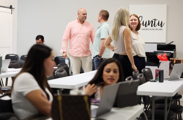 Employees talk in between meetings at Wemert Group Realty, one of the 2026 Top Workplaces in Central Florida, on Tuesday, September 22, 2026. (Ricardo Ramirez Buxeda/ Orlando Sentinel)