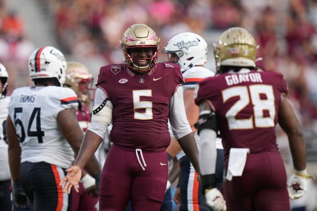 Florida State defensive lineman Daniel Lyons (5) celebrates a sack by Florida State linebacker Mikai Gbayor (28) in the second half during an NCAA college football game against Virginia in Tallahassee, Fla., Saturday, Oct. 3, 2026. (AP Photo/Peter Joneleit)