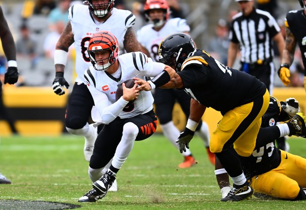 PITTSBURGH, PENNSYLVANIA - SEPTEMBER 27: Joe Burrow #9 of the Cincinnati Bengals avoids a tackle by Cameron Heyward #97 of the Pittsburgh Steelers during the third quarter at Acrisure Stadium on September 27, 2026 in Pittsburgh, Pennsylvania. (Photo by Joe Sargent/Getty Images)